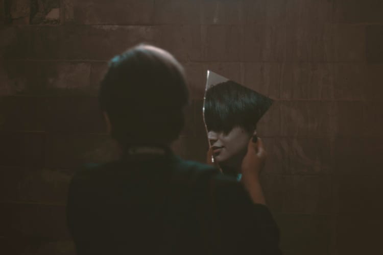 woman holding mirror